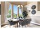 Dining room features a rustic wooden table, modern chairs, and large windows with natural light at 8922 S Tuscany Ln, Highlands Ranch, CO 80130