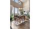 Elegant dining room with large windows, hardwood floors, and a stylish chandelier at 8922 S Tuscany Ln, Highlands Ranch, CO 80130