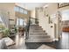 Inviting entryway boasting high ceilings, hardwood floors, carpeted stairs, and an open dining area at 8922 S Tuscany Ln, Highlands Ranch, CO 80130
