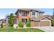 Charming home with brick accents, well-maintained lawn, and a convenient two-car garage at 8922 S Tuscany Ln, Highlands Ranch, CO 80130