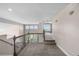 Upstairs hallway with carpet and railing overlooking the lower level at 8922 S Tuscany Ln, Highlands Ranch, CO 80130