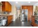 Contemporary kitchen with stainless steel appliances, custom cabinets, mosaic backsplash, and views to the entry at 8922 S Tuscany Ln, Highlands Ranch, CO 80130