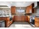 Spacious kitchen with wooden cabinetry, stainless steel appliances, granite countertops, and a functional design for cooking at 8922 S Tuscany Ln, Highlands Ranch, CO 80130