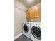 Laundry room with newer model washer and dryer with wood cabinets at 8922 S Tuscany Ln, Highlands Ranch, CO 80130