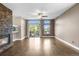 Inviting living room featuring a stone fireplace, wood floors, and sliding glass doors to a balcony at 8922 S Tuscany Ln, Highlands Ranch, CO 80130