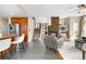 Cozy living room with open access to the kitchen, fireplace, and a staircase at 8922 S Tuscany Ln, Highlands Ranch, CO 80130