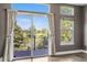 Bright living area with sliding glass doors leading to a deck with golf course views and ample natural light at 8922 S Tuscany Ln, Highlands Ranch, CO 80130