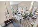 Open-concept living space with comfortable seating, large windows, and plenty of natural light at 8922 S Tuscany Ln, Highlands Ranch, CO 80130