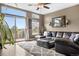 Cozy living room featuring a comfortable sectional sofa, plush rug, and scenic views from large windows at 8922 S Tuscany Ln, Highlands Ranch, CO 80130