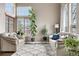 Bright living room featuring large windows, comfortable seating, and an inviting atmosphere at 8922 S Tuscany Ln, Highlands Ranch, CO 80130