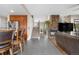 Spacious living area with open concept kitchen, breakfast bar and a cozy fireplace at 8922 S Tuscany Ln, Highlands Ranch, CO 80130