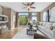 Inviting living room features a ceiling fan, a cozy couch, and backyard views at 8922 S Tuscany Ln, Highlands Ranch, CO 80130