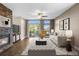 Comfortable living room with a stone fireplace, balcony, and a stylish rug that ties the space together at 8922 S Tuscany Ln, Highlands Ranch, CO 80130
