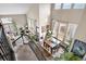 Sun-drenched living room and dining area showcasing high ceilings, abundant natural light, and stylish furnishings at 8922 S Tuscany Ln, Highlands Ranch, CO 80130