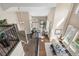 Open-concept living space with dining area and living room, featuring hardwood floors and natural light at 8922 S Tuscany Ln, Highlands Ranch, CO 80130