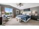 A serene main bedroom features a plush bed, a comfortable armchair, and scenic outdoor views at 8922 S Tuscany Ln, Highlands Ranch, CO 80130