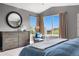 Main bedroom with a window view, soft decor, and a comfortable seating area at 8922 S Tuscany Ln, Highlands Ranch, CO 80130