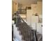 Carpeted staircase with decorative railing, leading to an open landing at 8922 S Tuscany Ln, Highlands Ranch, CO 80130