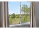 Window view of golf course with green fields and blue skies at 8922 S Tuscany Ln, Highlands Ranch, CO 80130
