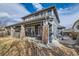 Spacious home exterior with a covered patio, featuring a barbecue area and ample seating at 333 Mesa St, Brighton, CO 80601