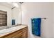 ' bathroom featuring a sink vanity with storage, neutral color and fun blue towels at 333 Mesa St, Brighton, CO 80601