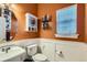 Cozy bathroom featuring a decorative mirror, storage cabinet, and white wainscoting at 333 Mesa St, Brighton, CO 80601
