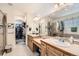 Bright bathroom with dual sinks, wooden cabinetry, a walk-in closet, and a separate shower at 333 Mesa St, Brighton, CO 80601