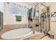 Relaxing bathroom with a soaking tub, a separate glass-enclosed shower, and natural light at 333 Mesa St, Brighton, CO 80601
