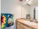 ' bathroom featuring a sink vanity with storage, neutral color and fun colorful towels at 333 Mesa St, Brighton, CO 80601