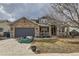 Inviting home showcasing a brick and siding exterior, complemented by a cozy front porch and mature landscaping at 333 Mesa St, Brighton, CO 80601