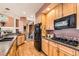 Well-equipped kitchen boasts wood cabinets, granite counters, and stainless steel appliances, and open floorplan at 333 Mesa St, Brighton, CO 80601