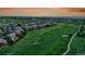 Breathtaking aerial view of the neighborhood highlighting lush green golf course and stunning mountain views in the distance at 27615 E Moraine Dr, Aurora, CO 80016