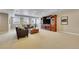 Comfortable basement living area with a sofa, chair, and large entertainment center, creating a cozy atmosphere at 27615 E Moraine Dr, Aurora, CO 80016