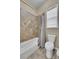 Bathroom featuring a tiled shower and toilet beneath a window at 27615 E Moraine Dr, Aurora, CO 80016