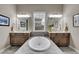 Bathroom featuring dual sinks and a large soaking tub at 27615 E Moraine Dr, Aurora, CO 80016