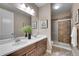 The primary bathroom features double sinks, a framed mirror, and a tiled shower at 27615 E Moraine Dr, Aurora, CO 80016