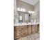 Bathroom with double sink vanity, modern lighting, and a large mirror at 27615 E Moraine Dr, Aurora, CO 80016
