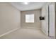 Minimalist bedroom with neutral carpet, window, and wall-mounted TV at 27615 E Moraine Dr, Aurora, CO 80016