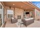 Enjoy the stone fireplace and outdoor television on this relaxing covered patio at 27615 E Moraine Dr, Aurora, CO 80016