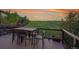 Outdoor deck with a dining table and chairs overlooking golf course at 27615 E Moraine Dr, Aurora, CO 80016