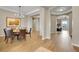 Open dining room with hardwood floors and modern chandelier fixture at 27615 E Moraine Dr, Aurora, CO 80016