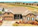 Inviting single-Gathering home boasts stone accents and a charming covered front porch at 27615 E Moraine Dr, Aurora, CO 80016