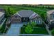 Beautiful home with stone and siding details, a well-manicured lawn, and an attached two-car garage in a golf community at 27615 E Moraine Dr, Aurora, CO 80016