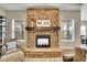 Close up of a stone fireplace and hearth with windows on both sides at 27615 E Moraine Dr, Aurora, CO 80016