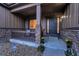 Welcoming front porch with stone accents, a dark-stained front door, and attractive landscaping at 27615 E Moraine Dr, Aurora, CO 80016