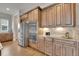 Chef's kitchen with stainless appliances, custom cabinetry, and granite counters at 27615 E Moraine Dr, Aurora, CO 80016