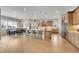 Open-concept kitchen with eat-in island, hardwood floors, and stainless steel appliances at 27615 E Moraine Dr, Aurora, CO 80016