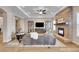 Spacious living room with stone fireplace, hardwood floors, and a cozy seating area at 27615 E Moraine Dr, Aurora, CO 80016