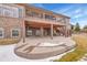 A spacious covered patio features a concrete slab and stone pillars at 27615 E Moraine Dr, Aurora, CO 80016