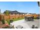 Backyard showcasing the patio, dining area, newly planted foliage, and a well-maintained fence at 23936 E River Front Dr, Aurora, CO 80019